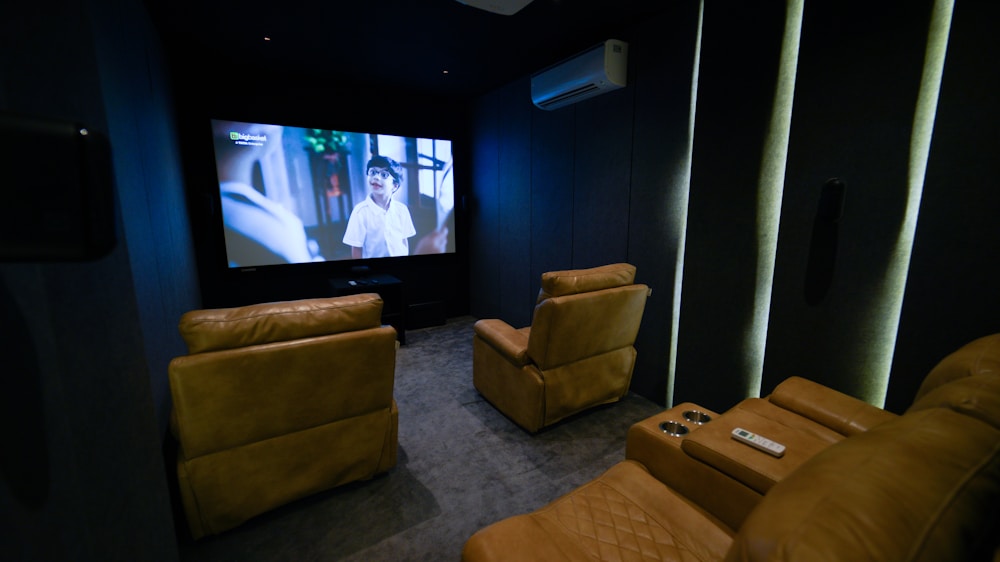 Dedicated home theater room with leather recliners and big screen