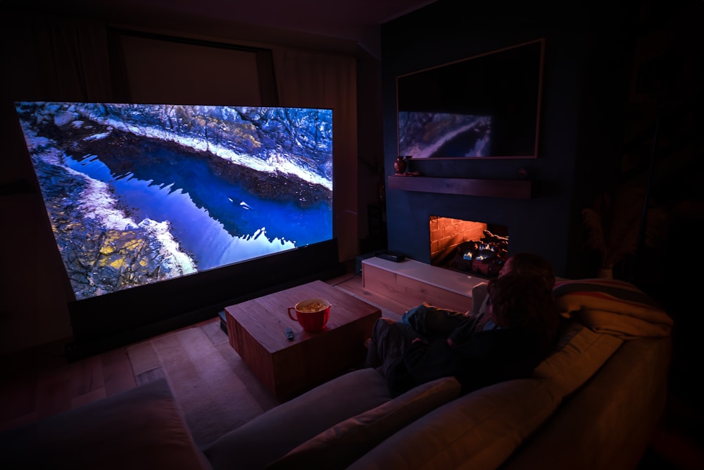 Dark room home cinema with projector and cozy seating